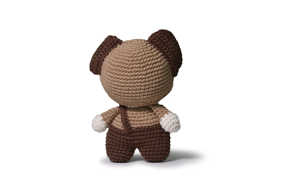 Completed Dog amigurumi on white background.