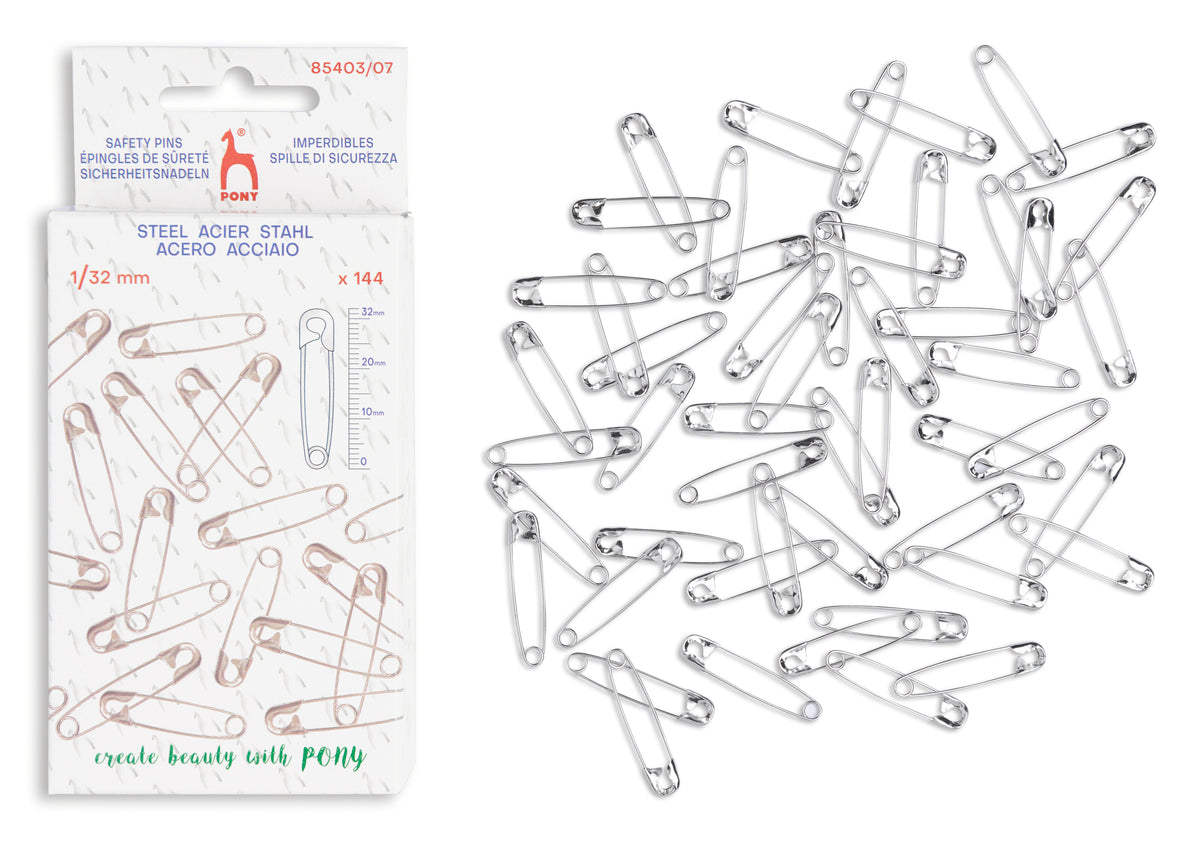 Pack of 144 steel safety pins in a white hanging card package, with several loose silver safety pins scattered on a white background.
